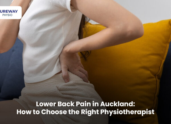 Physiotherapist helping a patient with lower back pain in Auckland